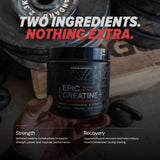 Person holding a container of Epic Creatine+ with gym equipment in the background